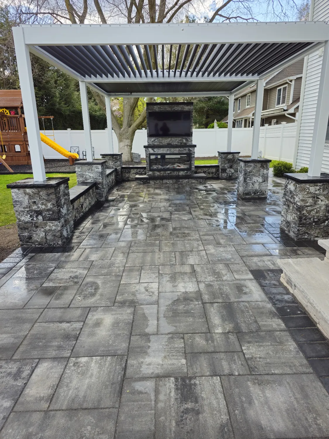 Backyard patio masonry with pavers and stonework by All United Construction