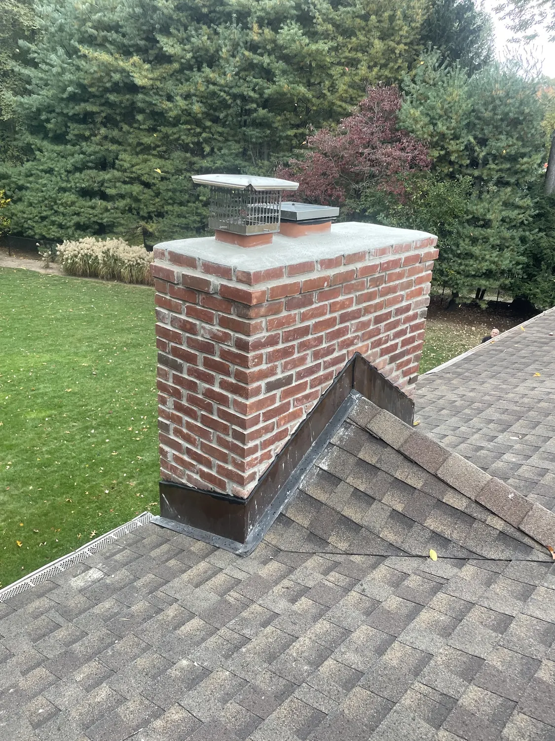 Chimney repair and flashing area on a New Jersey roof by All United Construction