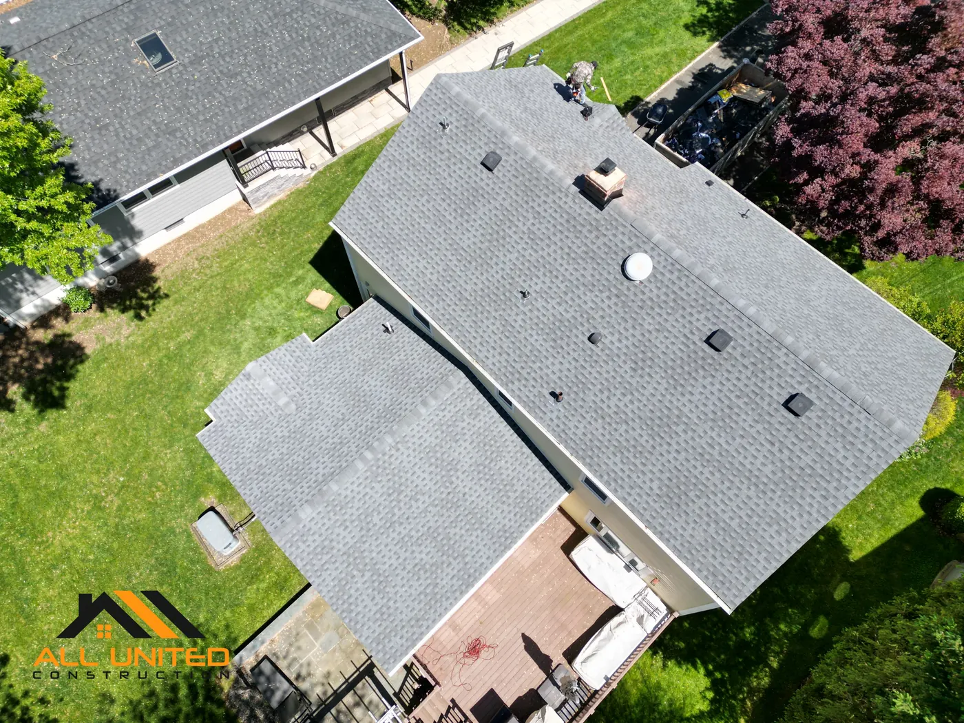Aerial view of completed asphalt shingle roof replacement on a New Jersey home